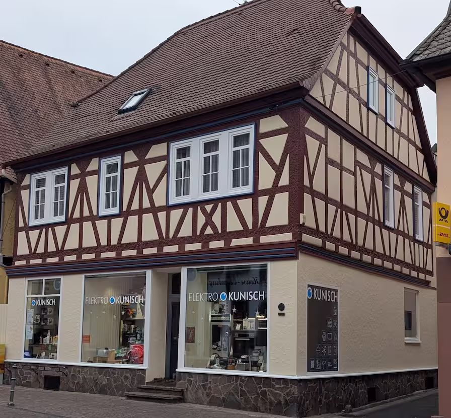 Restored timber-framed façade with light infill panels and exposed wooden beams